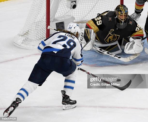 Marc-Andre Fleury of the Vegas Golden Knights makes a diving save against Patrik Laine of the Winnipeg Jets during the second period Game Four of the...