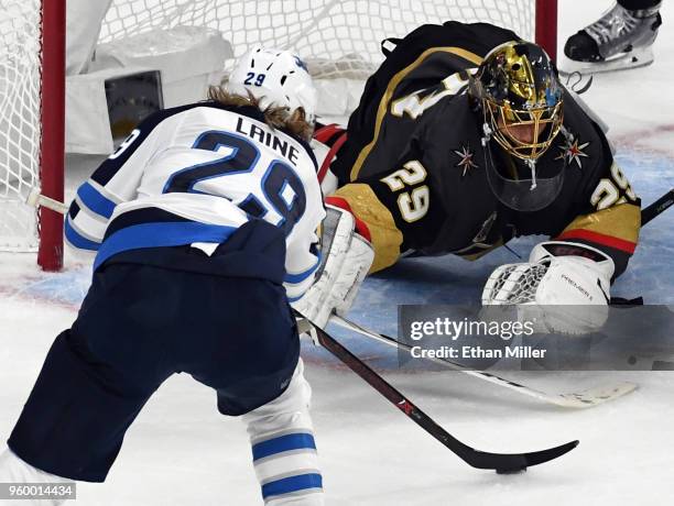 Marc-Andre Fleury of the Vegas Golden Knights makes a diving save against Patrik Laine of the Winnipeg Jets during the second period Game Four of the...