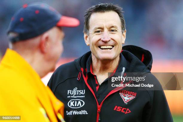 Bombers head coach John Worsfold reacts during the ANZAC observance during the round nine AFL match between the Essendon Bombers and the Geelong Cats...