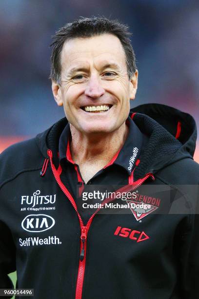 Bombers head coach John Worsfold reacts during the ANZAC observance during the round nine AFL match between the Essendon Bombers and the Geelong Cats...