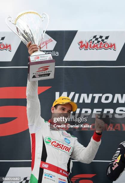 Race winner Rick Kelly driver of the Nissan Motorsport Nissan Altima celebrates on the podium during race 13 for the Supercars Winton SuperSprint on...