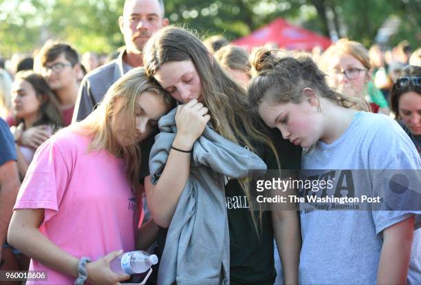 Santa Fe High school students Alexis Markis, Kassidy Taves and Averi Gary hold each other during a vigil for the victims of the Santa Fe High School...