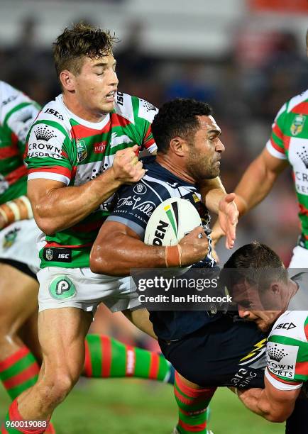 Justin O'Neil of the Cowboys is tackled by Cameron Murray and Damien Cook of the Rabbitohs during the round 11 NRL match between the North Queensland...