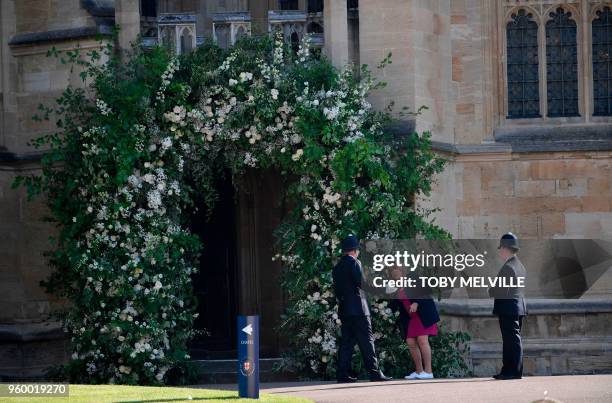 Flower arranger does last-minute preparations outside St George's Chapel in Windsor Castle ahead of the wedding and carriage procession of Britain's...