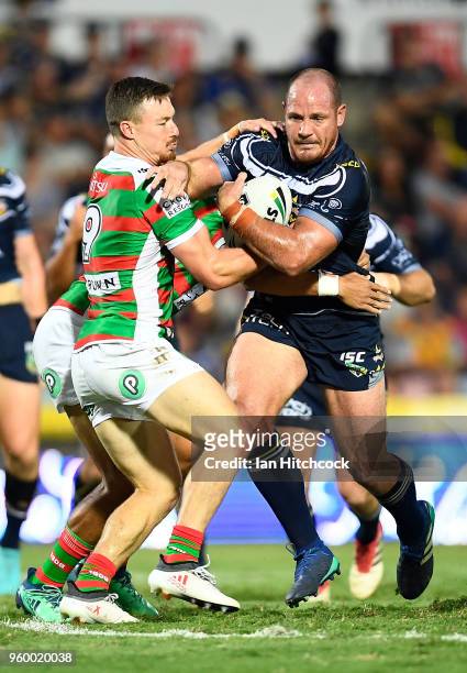 Matthew Scott of the Cowboys is tackled by Damien Cook of the Rabbitohs during the round 11 NRL match between the North Queensland Cowboys and the...