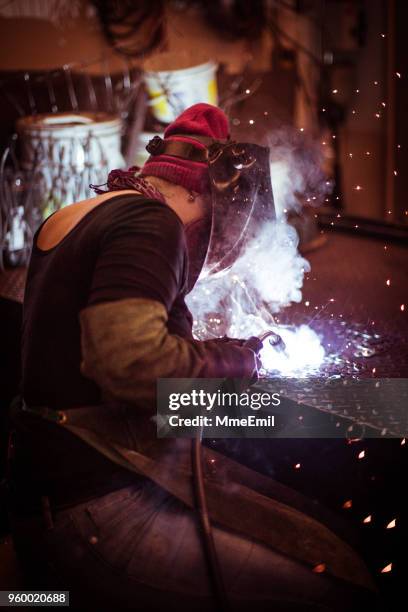 female welder working in a workshop. metal industry worker - middle class female stock pictures, royalty-free photos & images