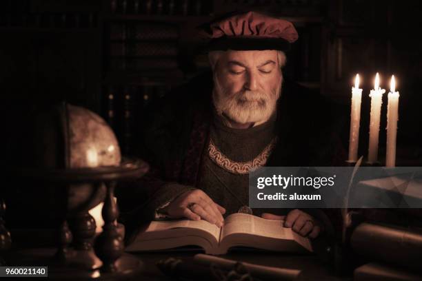 senior scholar of the past reading book in old library - scribe stock pictures, royalty-free photos & images