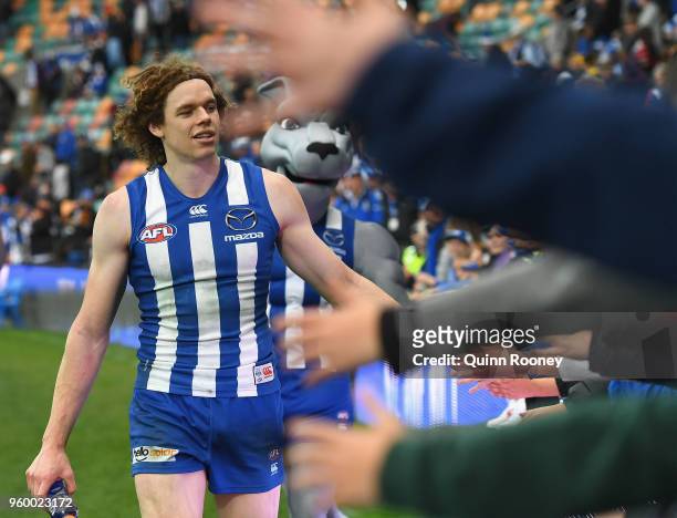 Ben Brown of the Kangaroos high fives fans after winning the round nine AFL match between the North Melbourne Kangaroos and the Greater Western...
