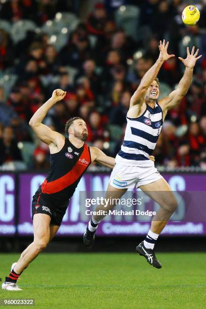 Tom Hawkins of the Cats marks the ball against Cale Hooker of the Bombers during the round nine AFL match between the Essendon Bombers and the...