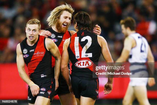 Devon Smith Dyson Heppell and Mark Baguley of the Bombers celebrates a goal during the round nine AFL match between the Essendon Bombers and the...