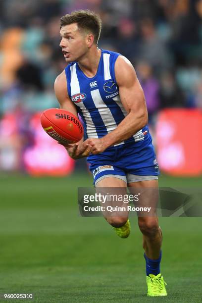 Shaun Higgins of the Kangaroos handballs during the round nine AFL match between the North Melbourne Kangaroos and the Greater Western Sydney Giants...
