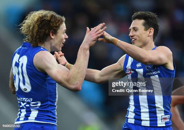 Ben Brown of the Kangaroos is congratulated by Ben Jacobs after kicking a goal during the round nine AFL match between the North Melbourne Kangaroos...