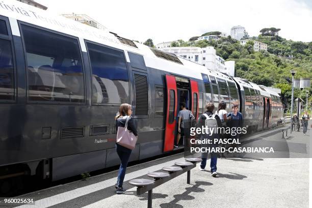 Students step on the train in Bastia railway station on May 15, 2018 in Bastia on the French Mediterranean island of Corsica.