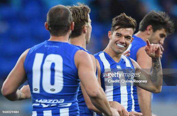 Jy Simpkin of the Kangaroos is congratulated by team mates after kicking a goal during the round nine AFL match between the North Melbourne Kangaroos...
