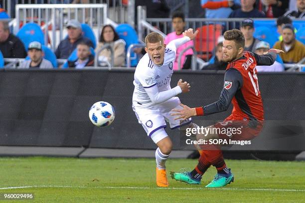 Chris Mueller and Eriq Zavaleta seen during the 2018 MLS Regular Season match between Toronto FC and Orlando City SC at BMO Field .