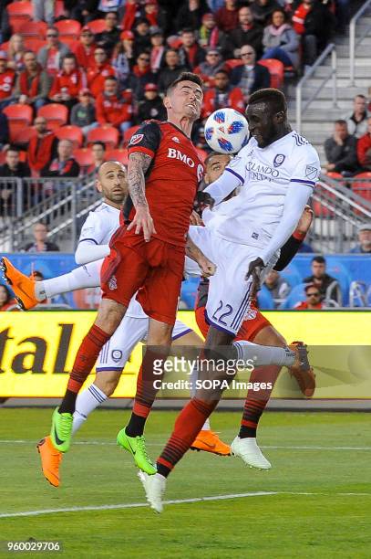 Jay Chapman and Lamine Sané seen jumping for the ball during 2018 MLS Regular Season match between Toronto FC and Orlando City SC at BMO Field .