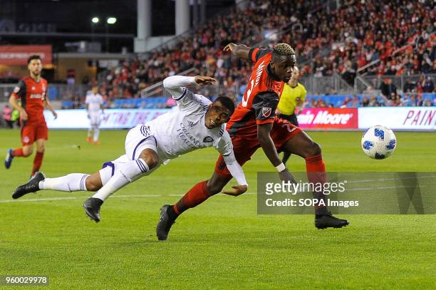 Stéfano Pinho and Chris Mavinga seen fighting for the ball during 2018 MLS Regular Season match between Toronto FC and Orlando City SC at BMO Field .