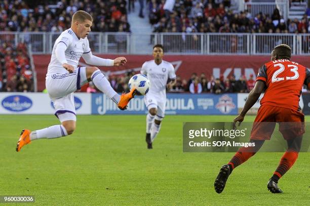 Chris Mueller jumping for the ball during 2018 MLS Regular Season match between Toronto FC and Orlando City SC at BMO Field .