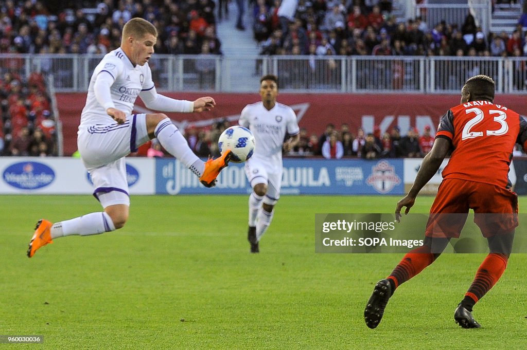 Chris Mueller (L) jumping for the ball during 2018 MLS...