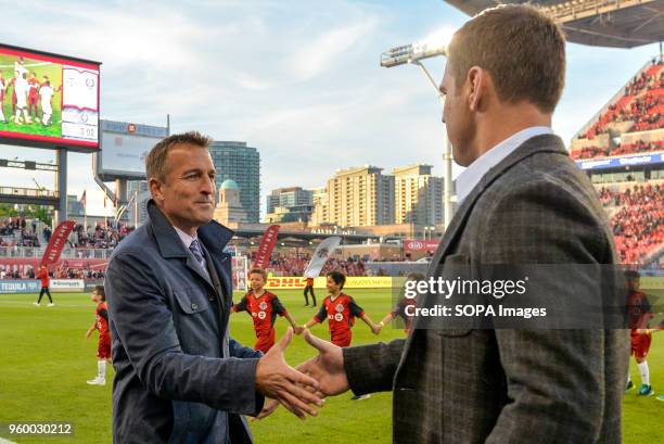 Jason Kreis greeting with Greg Vanney before the 2018 MLS Regular Season match between Toronto FC and Orlando City SC at BMO Field .