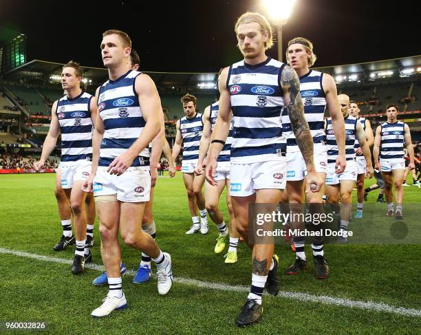 Tom Stewart of the Cats and Joel Selwood lead the team off after defeat during the round nine AFL match between the Essendon Bombers and the Geelong...