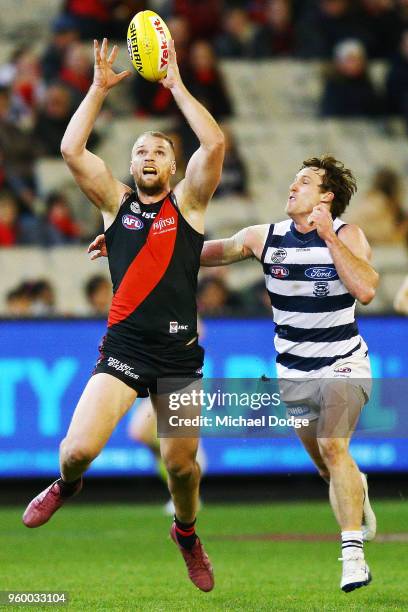 Jake Stringer of Essendon compete for the ball against Jed Bews of the Cats during the round nine AFL match between the Essendon Bombers and the...