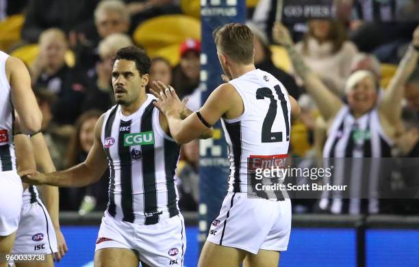 Daniel Wells of the Magpies is congratulated by his teammates after kicking a goal during the round nine AFL match between the St Kilda Saints and...