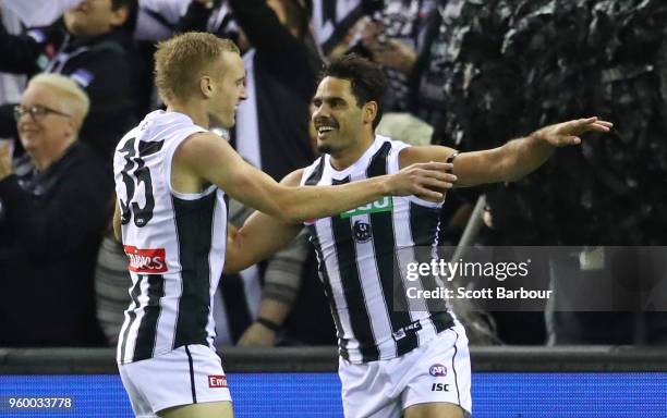 Daniel Wells of the Magpies is congratulated by Jaidyn Stephenson of the Magpies after kicking a goal during the round nine AFL match between the St...