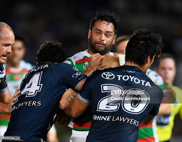 John Sutton of the Rabbitohs is tackled by Te Maire Martin and Enari Tuala of the Cowboys during the round 11 NRL match between the North Queensland...