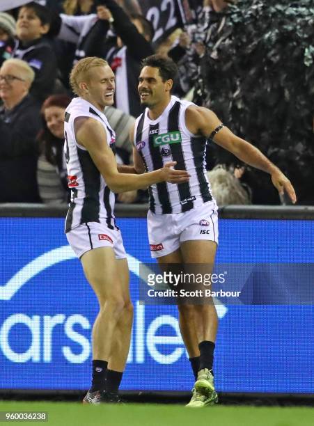 Daniel Wells of the Magpies is congratulated by Jaidyn Stephenson of the Magpies after kicking a goal during the round nine AFL match between the St...