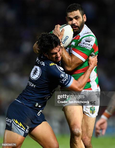 Greg Inglis of the Rabbitohs is tackled by Enari Tuala of the Cowboys during the round 11 NRL match between the North Queensland Cowboys and the...