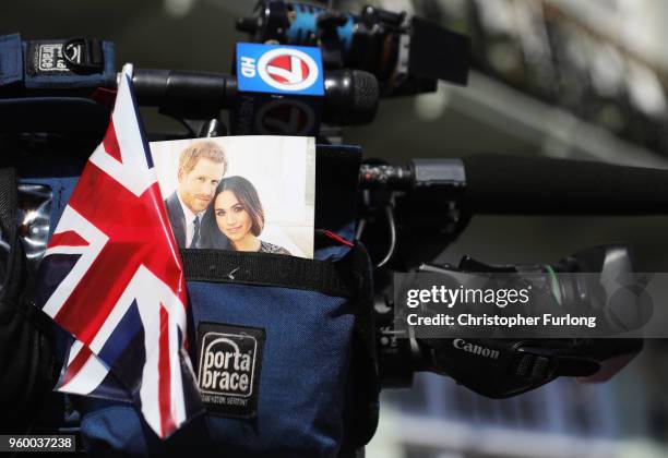 Union Jack flag and a photo of Harry and Meghan sits on TV camera during the wedding of Prince Harry Harry to Ms. Meghan Markle St George's Chapel,...