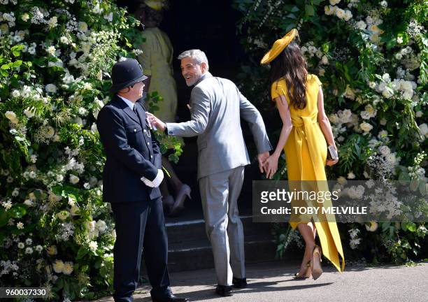 Actor George Clooney and his wife Amal Clooney arrive for the wedding ceremony of Britain's Prince Harry, Duke of Sussex and US actress Meghan Markle...
