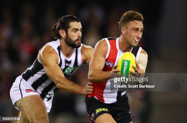 Luke Dunstan of the Saints is tackled by Brodie Grundy of the Magpies during the round nine AFL match between the St Kilda Saints and the Collingwood...