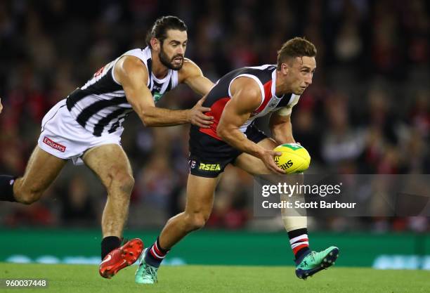 Luke Dunstan of the Saints is tackled by Brodie Grundy of the Magpies during the round nine AFL match between the St Kilda Saints and the Collingwood...