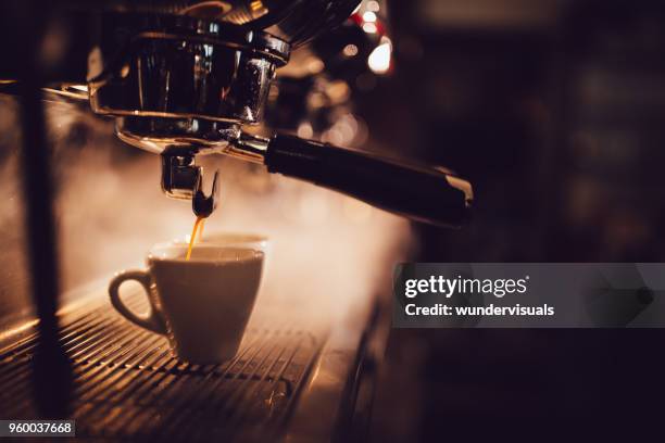 close-up of espresso machine brewing a cup of coffee - italian cafe culture stock pictures, royalty-free photos & images