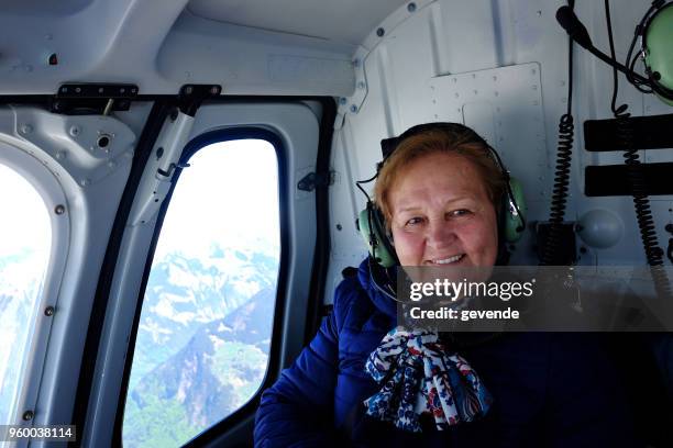 senior woman in helicopter flight - helicopter ambulance stock pictures, royalty-free photos & images