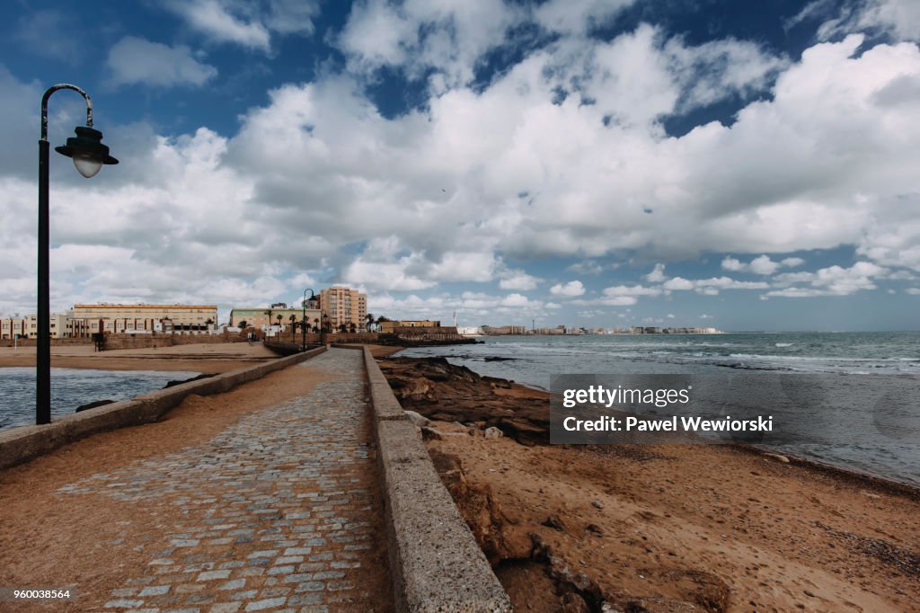 Empty promenade leading to city Cadiz, Spain