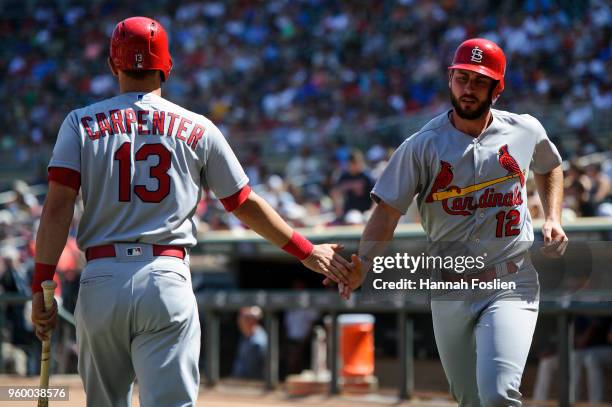 Matt Carpenter congratulates teammate Paul DeJong on scoring a run against the Minnesota Twins during the interleague game on May 16, 2018 at Target...