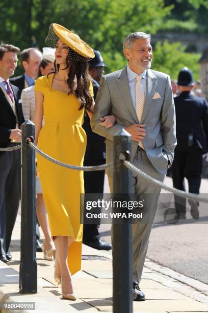 Amal Clooney and George Clooney arrive at St George's Chapel at Windsor Castle before the wedding of Prince Harry to Meghan Markle on May 19, 2018 in...