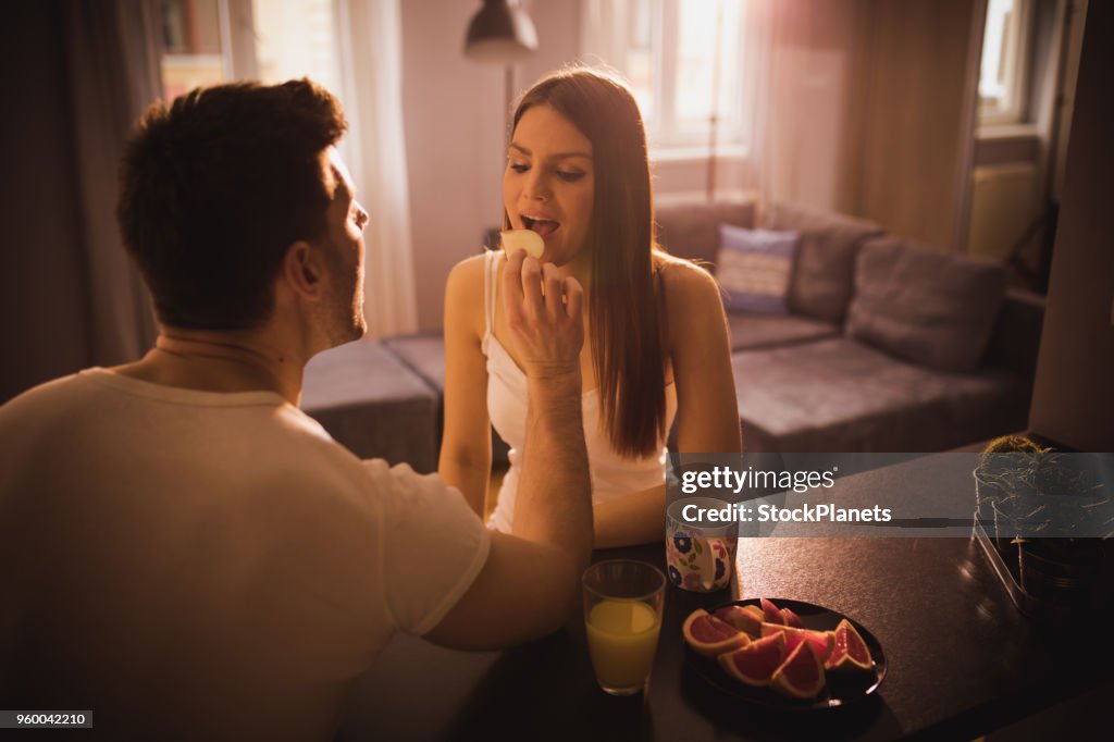 Young couple having fun at the breakfast