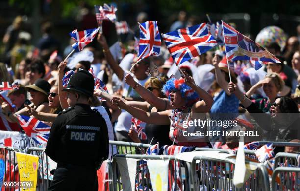 Well-wishers wave flags on the Long Walk leading to Windsor Castle ahead of the wedding and carriage procession of Britain's Prince Harry, Duke of...