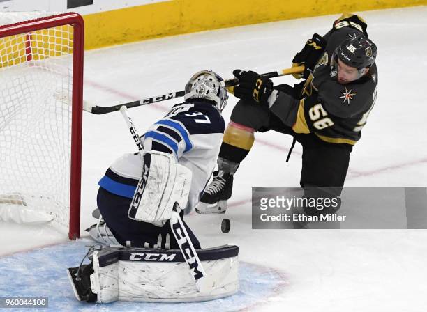 Connor Hellebuyck of the Winnipeg Jets blocks a shot by Erik Haula of the Vegas Golden Knights in the first period of Game Four of the Western...