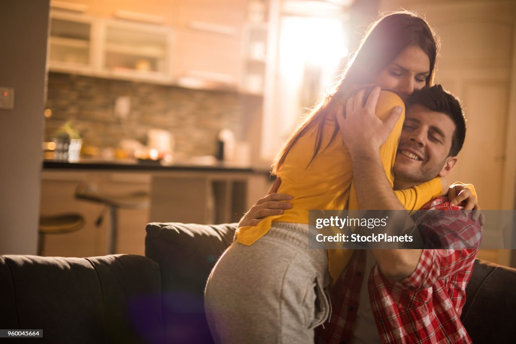 Happy couple embracing in the sunny morning