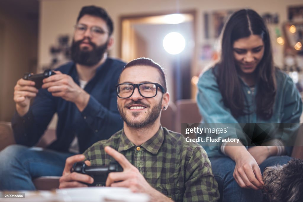 Good friends playing games at home