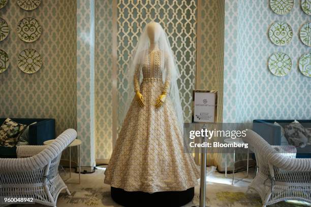 Wedding dress created by Sebastian Gunawan, an Indonesian high-fashion designer, stands on display during a wedding exhibition in the hotel lobby of...