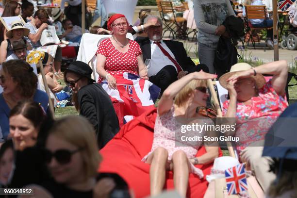 People dressed for the occasion attend a public viewing to watch the British royal wedding of Prince Harry to Meghan Markle at the The Cottage Tea...