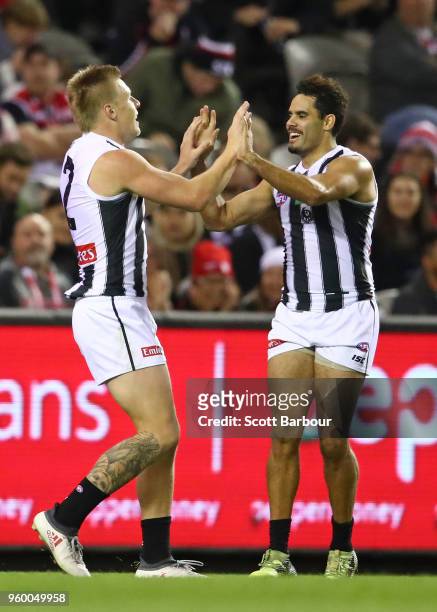 Jordan De Goey of the Magpies and Daniel Wells of the Magpies celebrate after kicking a goal during the round nine AFL match between the St Kilda...
