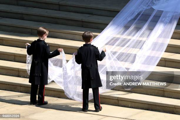 Page boys John and Brian Mulroney accompany US actress Meghan Markle as she arrives in a car for the wedding ceremony to marry Britain's Prince...