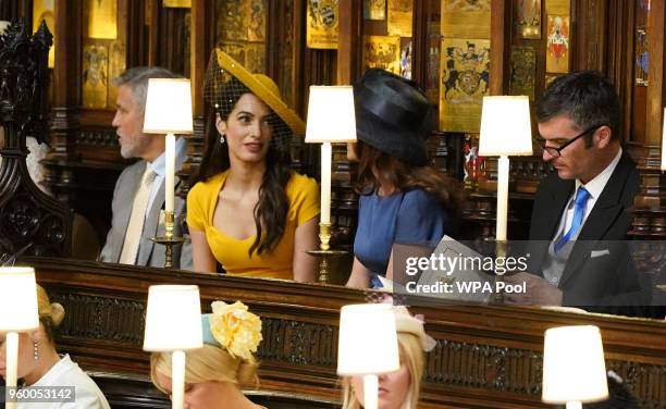 George Clooney, Amal Clooney, Silver Tree and Abraham Levy take their seats in St George's Chapel at Windsor Castle before the wedding of Prince...